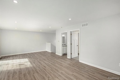 Spare room featuring recessed lighting and wood finished floors