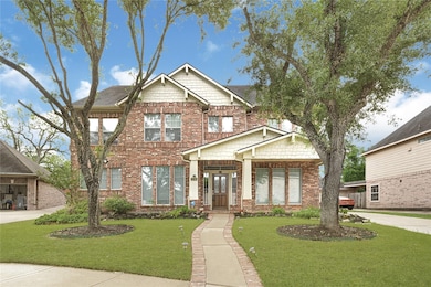 Elegant front elevation with mature landscaping an