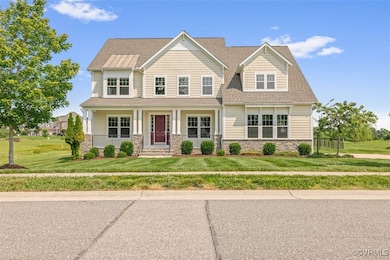 Craftsman-style home featuring stone siding, cover
