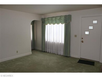 The great room is carpeted and leads into the kitc