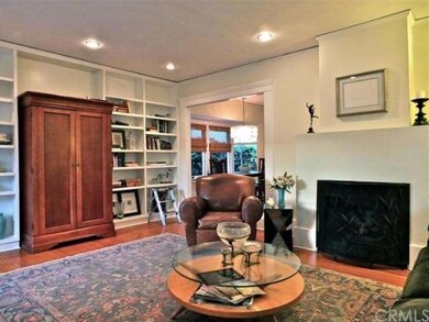 Living room has one full wall of beautiful built i