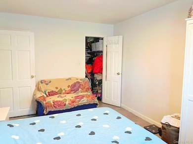 Bedroom featuring wood finished floors and baseboards