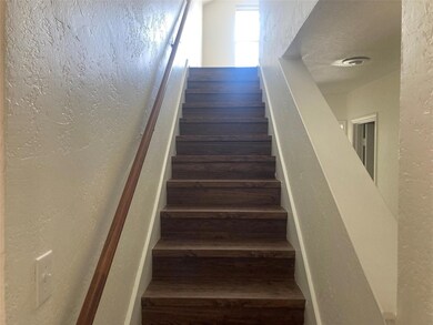 Staircase featuring hardwood / wood-style floors