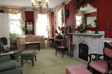 The parlor features nearly floor to ceiling window