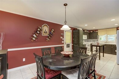 Dining room features tile flooring, chair rail mol