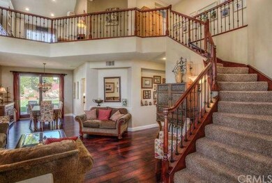 Elegant curved staircase with wrought iron and cus
