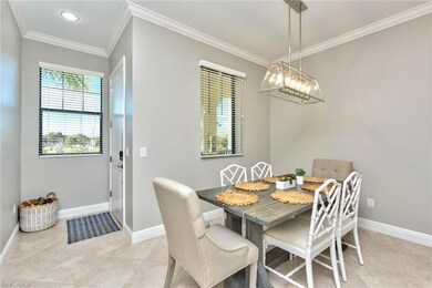 Entry foyer + dining area with updated light fixtu