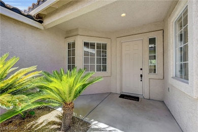 View of exterior entry with stucco siding