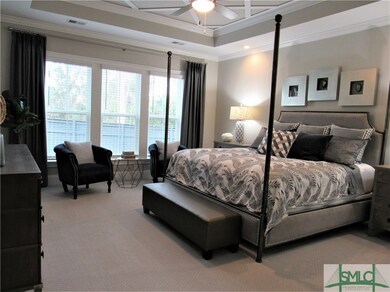 First floor master bedroom suite includes tray cei