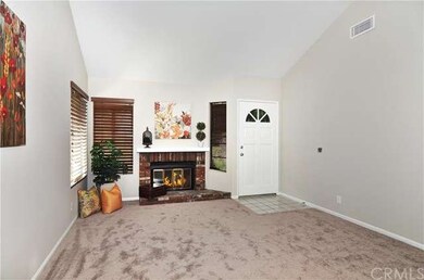 large livingroom with a crackling fireplace with n