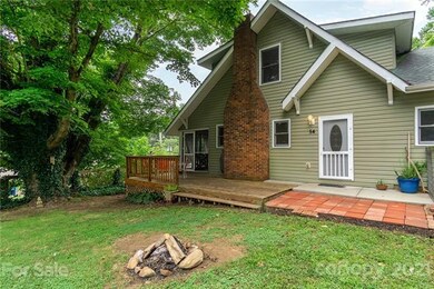 Little fire pit to gather around and toast marshmallows. Enjoy the shade from that lovely tree.