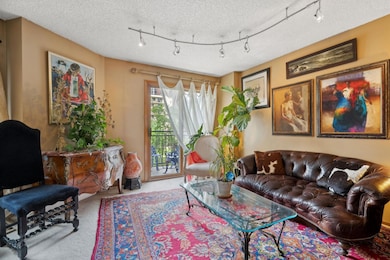 Living room has views onto the award winning designed plaza / greenspace