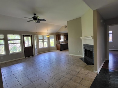 Unfurnished living room featuring light tile patt