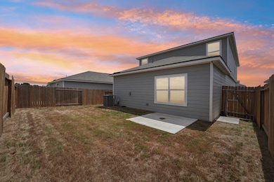 Rear view of house with a patio area and a fenced backyard
