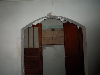 Walls are concrete, paint needs to be scraped off.