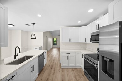 Kitchen with pendant lighting, white cabinets, and