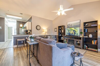 Living room featuring ceiling fan, lofted ceiling,