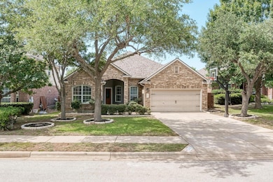 View of front facade featuring a garage, brick si
