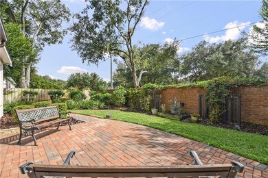 Spacious open air brick patio seating surrounded b