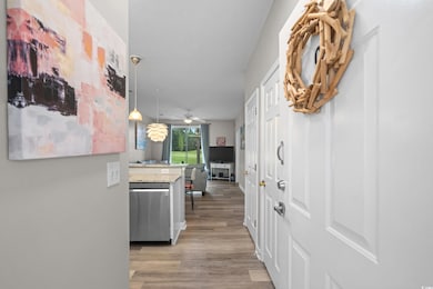 Hall with light wood finished floors and baseboards