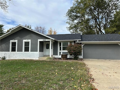 Single story home featuring concrete driveway, a front yard, roof with shingles, a garage, and covered porch