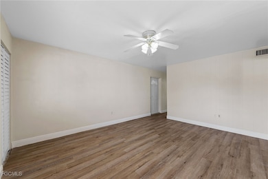 Unfurnished bedroom featuring wood finished floors and ceiling fan