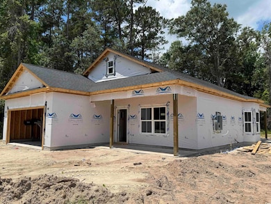 Property in mid-construction featuring a garage, a shingled roof, and covered porch