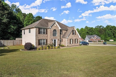 View of front of home featuring fence, a shingled 