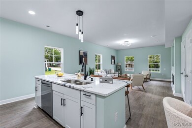 Kitchen featuring sink, pendant lighting, a center