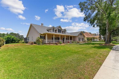 Front exterior view of 2202 Colewood Ln in Dover, Florida – with well maintained landscaping.