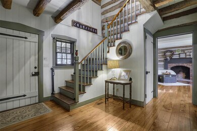 Open spindle staircase in two-story entry foyer