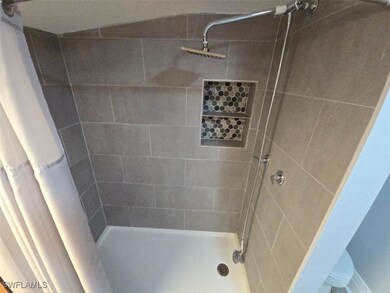Bathroom featuring a tile shower
