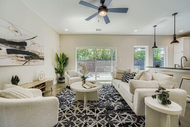 Living room with a ceiling fan and recessed lighting