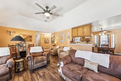 The living room, leading into the dining area and