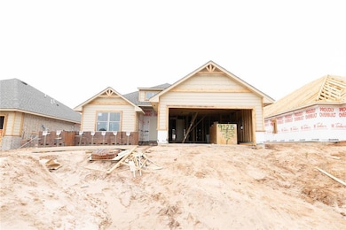 Property under construction with brick siding and a garage