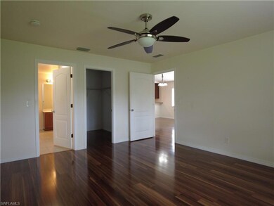 Unfurnished bedroom with ceiling fan, a closet, hardwood / wood-style floors, and a spacious closet