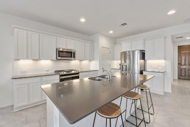 Kitchen featuring a sink, a breakfast bar, applia