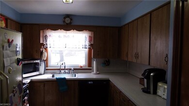 Kitchen faces deep backyard.