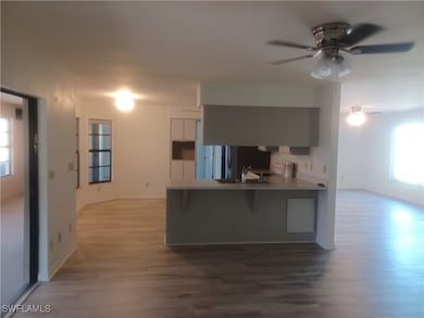Kitchen featuring a ceiling fan, light wood-style