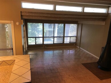 Unfurnished living room featuring baseboards