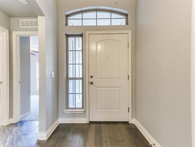 Foyer entrance with dark hardwood / wood-style flo