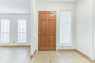 Bright front entry with double windows allowing natural light to fill the space, creating a warm and welcoming first impression.