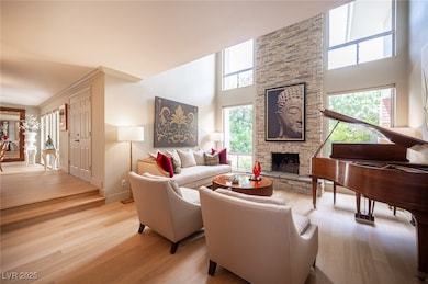 Living room featuring a high ceiling, a fireplace,