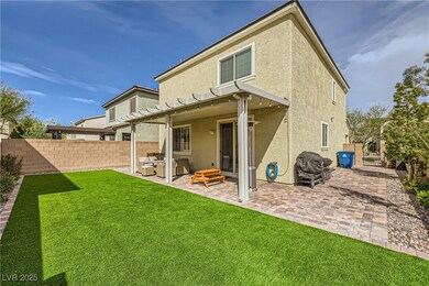 Back of property with stucco siding, fence, a yard