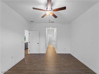 Unfurnished bedroom with baseboards, dark wood-typ