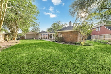 Spacious backyard with lush green grass, mature tr