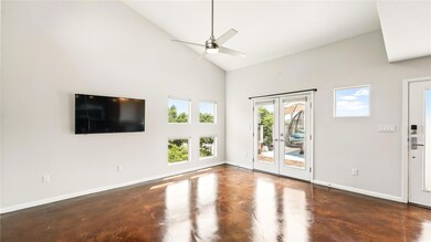 Empty room featuring concrete flooring, high vaul