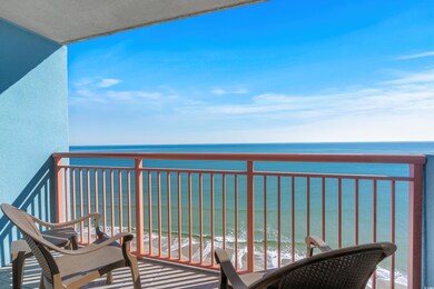 Balcony featuring a water view and a beach view