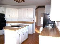 Kitchen has loads of cabinets, pantry, eating nook.