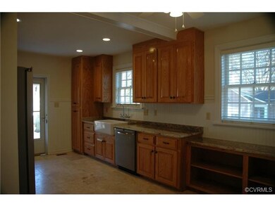 Wonderful brand NEW kitchen with Fossil stamped tile floor, custom made wood cabinets, granite counters, stainless steel appliances, and oversized farmhouse style sink